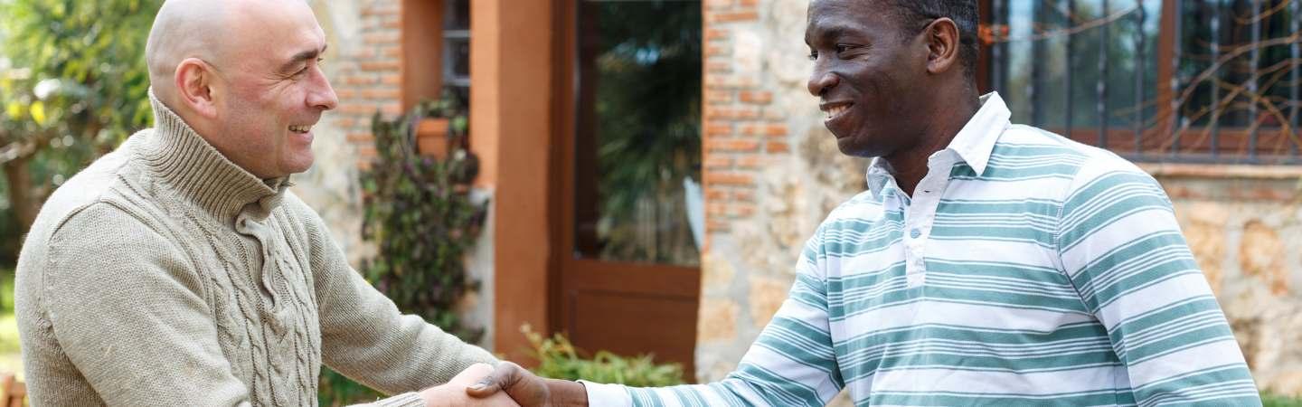 Two neighbours shaking hands
